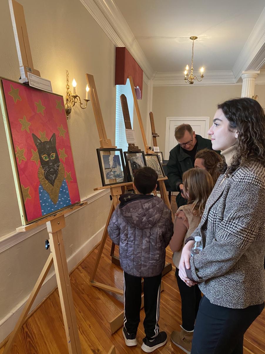 50/50 Club Officer Alice Merolli contemplates “Snazzy Cat” by Leila Watt (photo courtesy of Margaret Gammie)