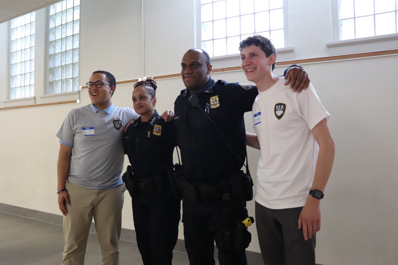 Taji Chesimet (left), two members of Portland Bureau of Police, and Britt Masback (right). (Photo courtesy Youth Educating Police)