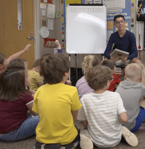 Teacher speaking in front of a group of students